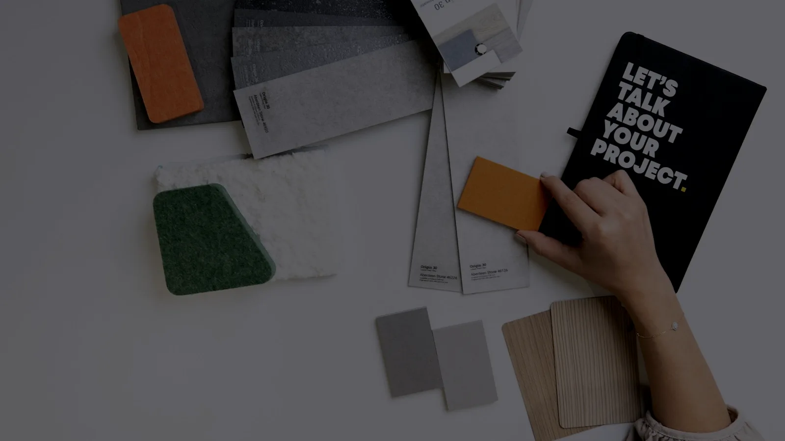 Colour and material swatches laid out on a desk